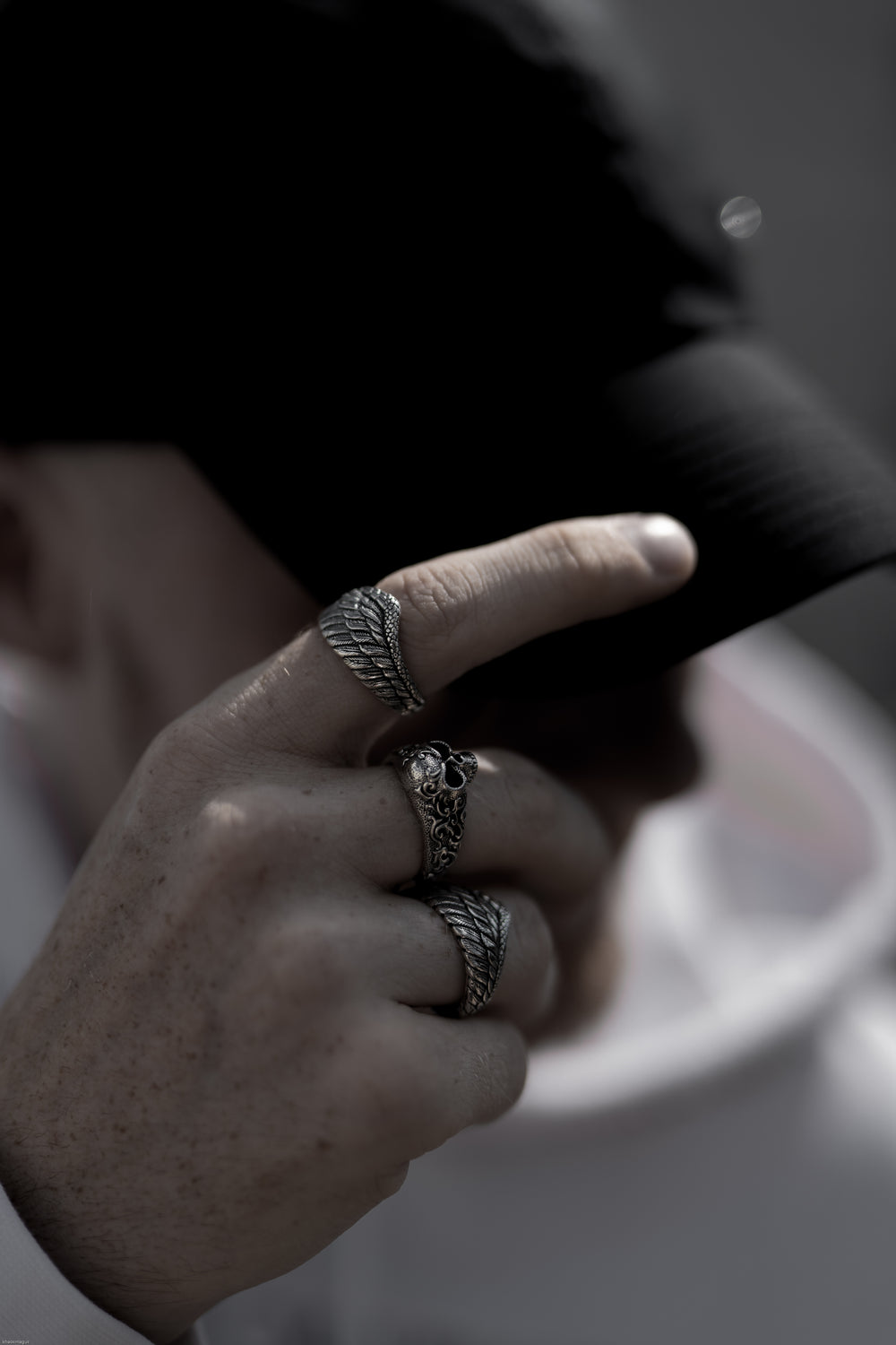 experience gothic and elegant fashion jewelry brand of steel wings and skull ring jewelry that can be enjoyed by any gender. man wearing silver skull ring with angel steel wings jewelry for gothic and streetwear fashion