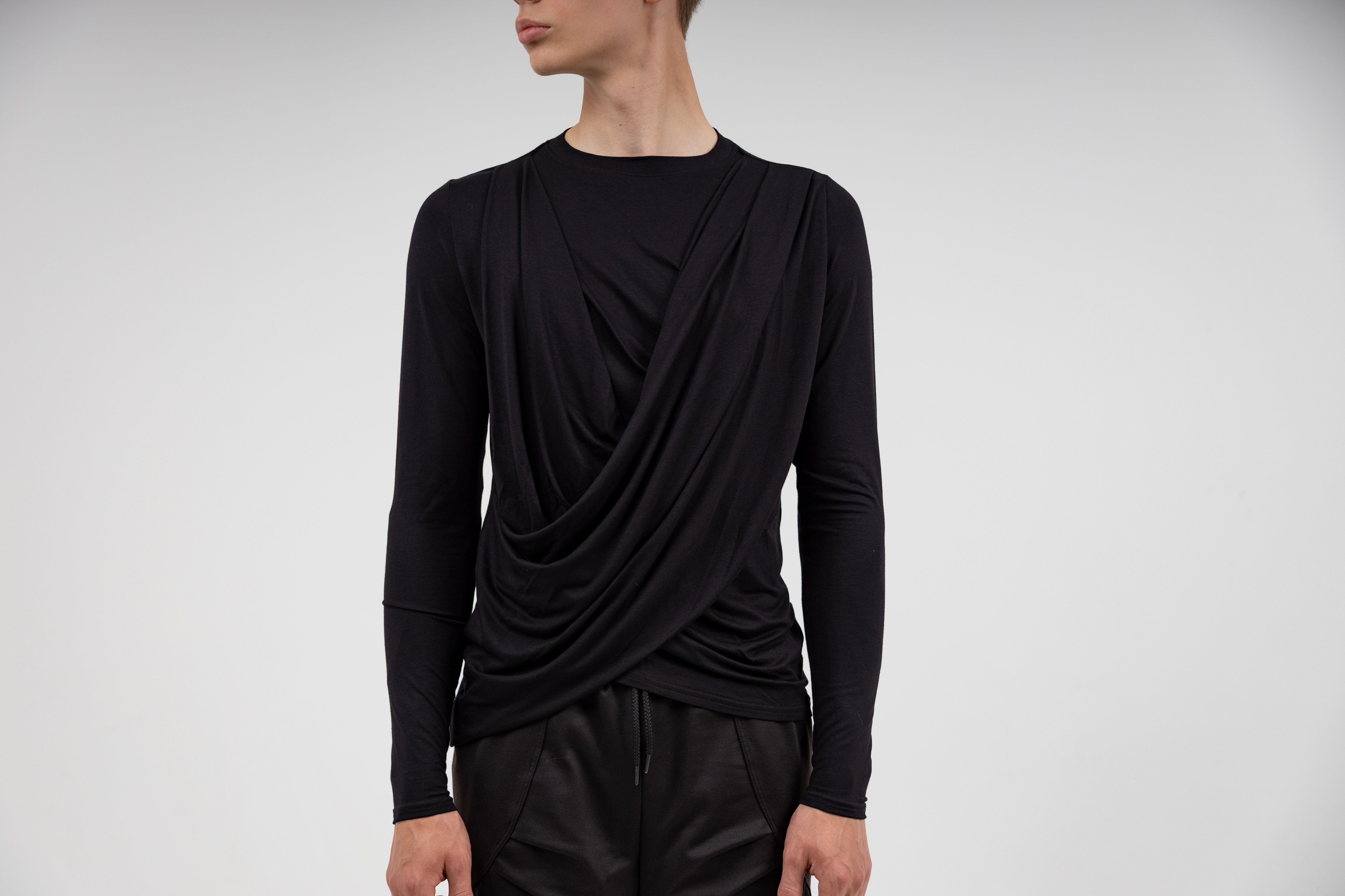minimal neo nomadic fashion clothing showcased by a male model in white background