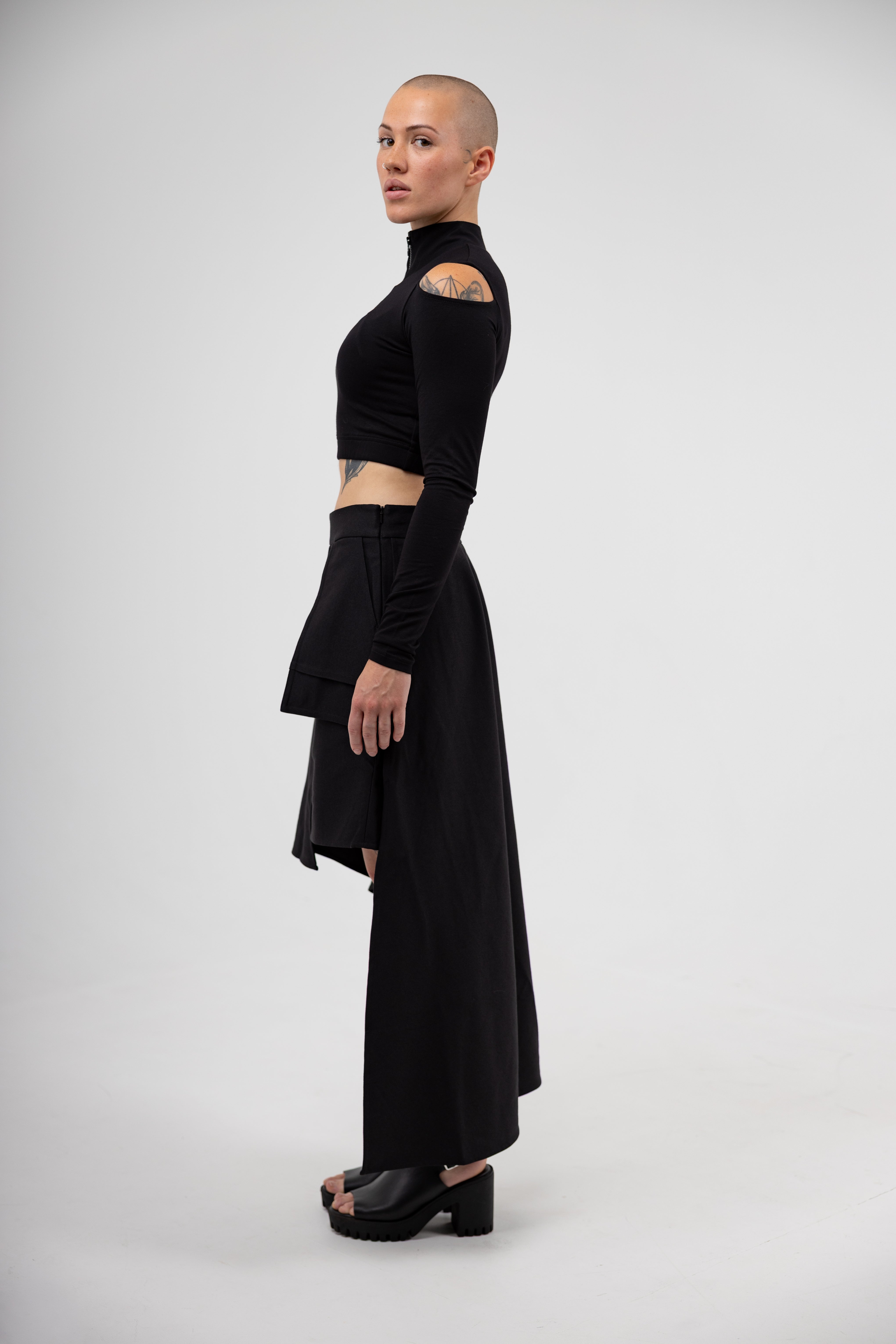Person wearing a black outfit on a white background